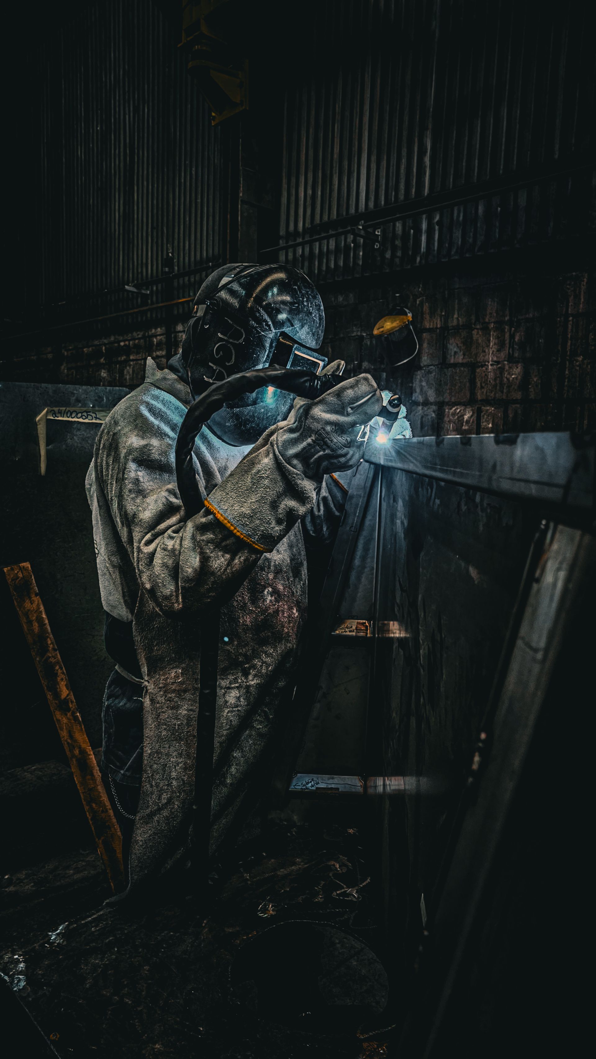 Industrial welding during metal fabrication, with protective equipment and sparks